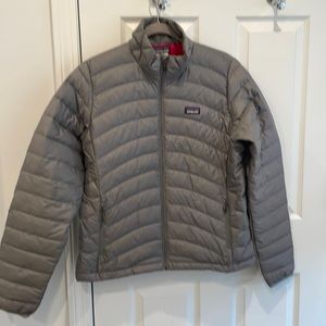 Brand new Patagonia jacket. Grey exterior with beautiful pink interior.